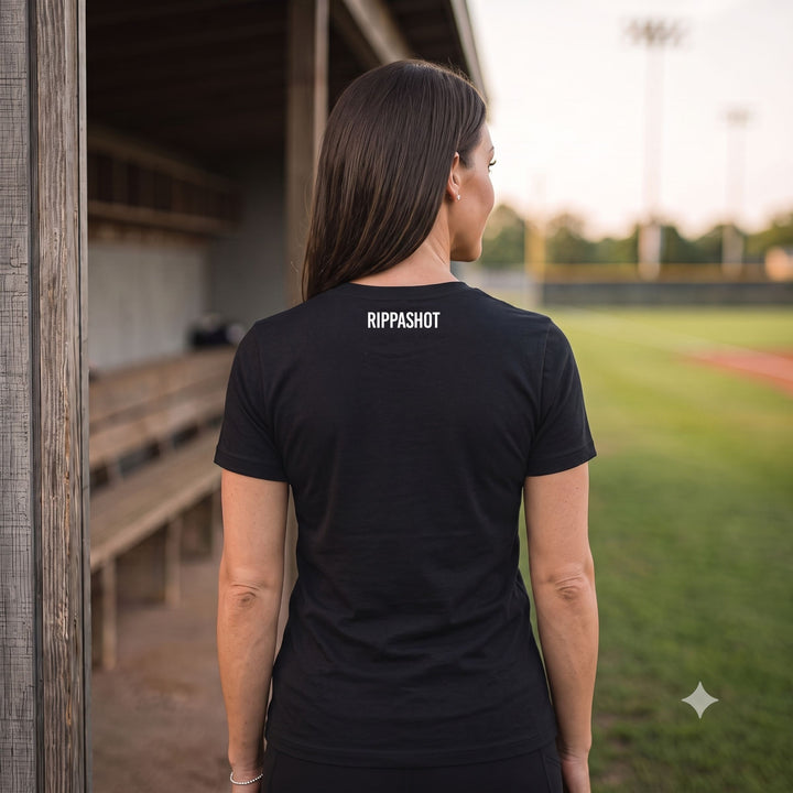 A woman viewed from behind wearing a black short-sleeve t-shirt with &