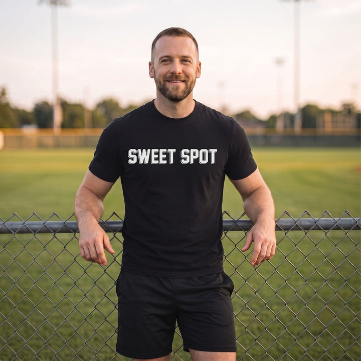 A man wearing a RIPPASHOT black t-shirt with &